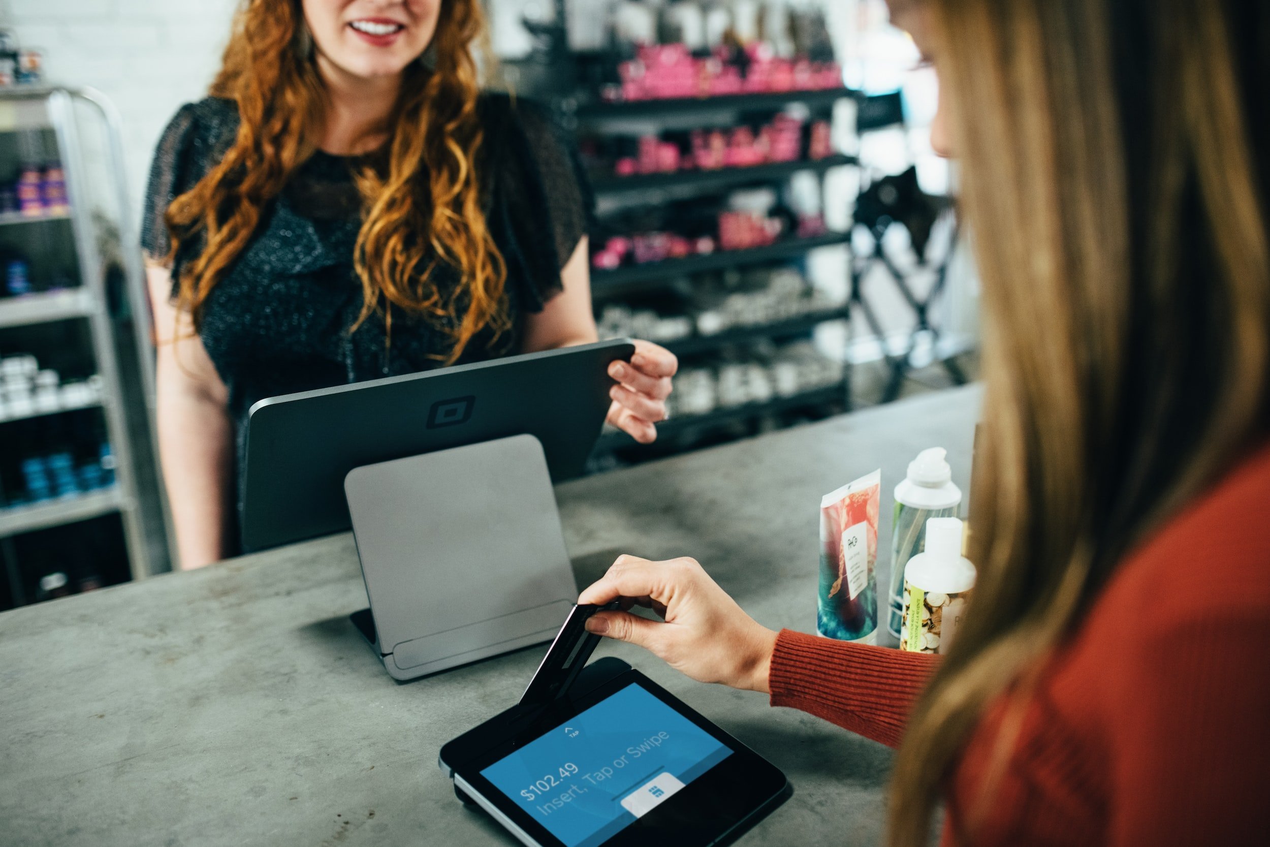 lady swiping a card at the till