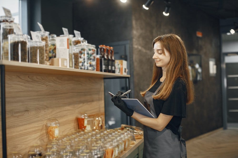 Retailer completing a store visit checklist